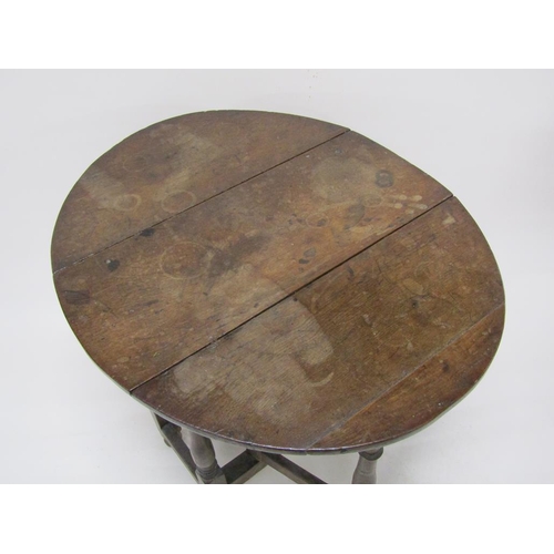 303 - An 18c oak twin flap oval gateleg table, 78cm w, 70cm h.