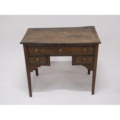 306 - A late Georgian oak and elm country lowboy of rectangular form with one long drawer over two short d... 