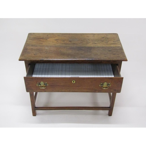 307 - A late Georgian oak panel top side table, fitted one long deep drawer and supported on square chamfe... 