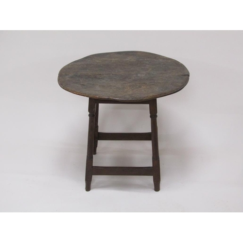 308 - An early 18c oak circular table supported on four turned and carved legs with box stretcher rails, 6... 