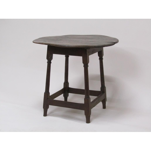 308 - An early 18c oak circular table supported on four turned and carved legs with box stretcher rails, 6... 