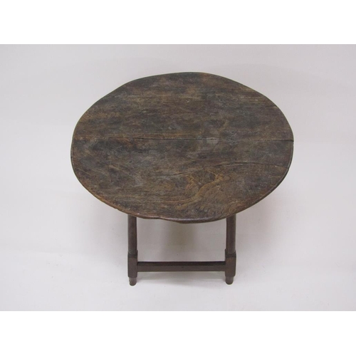 308 - An early 18c oak circular table supported on four turned and carved legs with box stretcher rails, 6... 