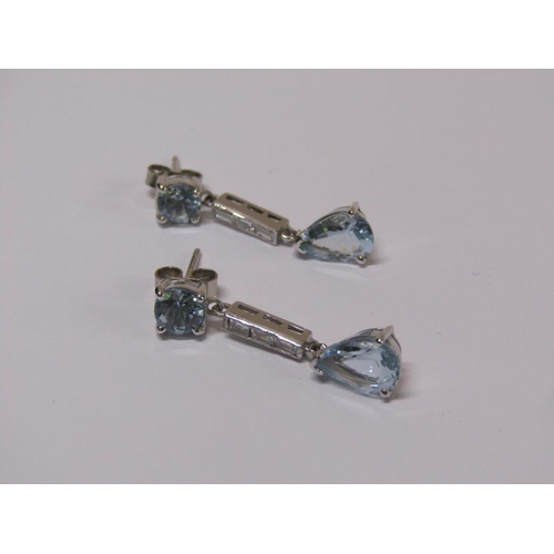 100 - A pair of 18ct white gold aquamarine and baguette cut diamond drop earrings.