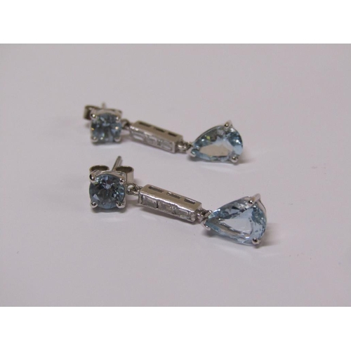 100 - A pair of 18ct white gold aquamarine and baguette cut diamond drop earrings.