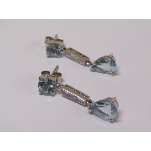 100 - A pair of 18ct white gold aquamarine and baguette cut diamond drop earrings.