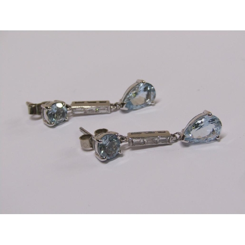 100 - A pair of 18ct white gold aquamarine and baguette cut diamond drop earrings.