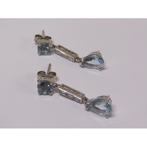 100 - A pair of 18ct white gold aquamarine and baguette cut diamond drop earrings.