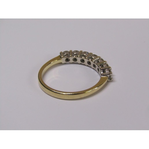 101 - An 18ct gold seven stone diamond half eternity ring, size m 1/2.