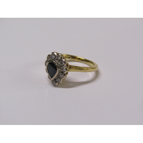 102 - An 18ct gold diamond and sapphire pear shaped ring, eleven brilliant diamonds surrounding a pear sha... 