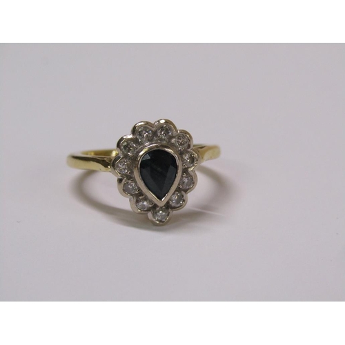 102 - An 18ct gold diamond and sapphire pear shaped ring, eleven brilliant diamonds surrounding a pear sha... 