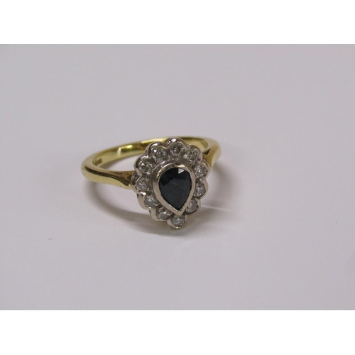 102 - An 18ct gold diamond and sapphire pear shaped ring, eleven brilliant diamonds surrounding a pear sha... 