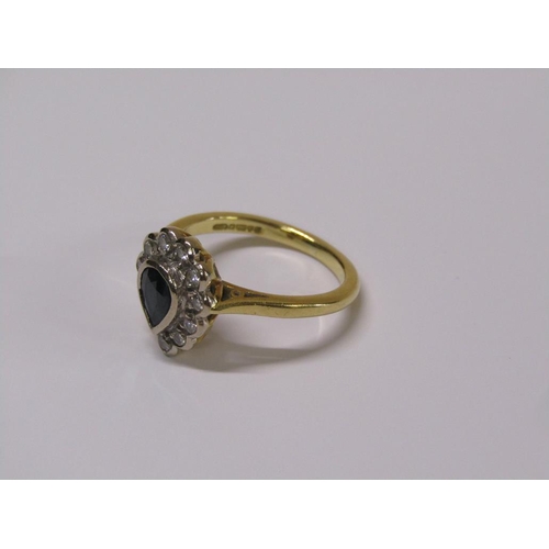 102 - An 18ct gold diamond and sapphire pear shaped ring, eleven brilliant diamonds surrounding a pear sha... 