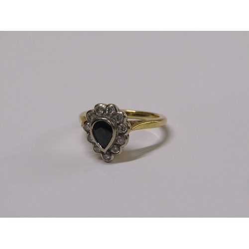 102 - An 18ct gold diamond and sapphire pear shaped ring, eleven brilliant diamonds surrounding a pear sha... 