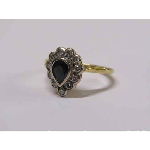 102 - An 18ct gold diamond and sapphire pear shaped ring, eleven brilliant diamonds surrounding a pear sha... 