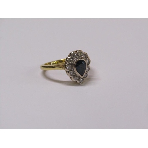 102 - An 18ct gold diamond and sapphire pear shaped ring, eleven brilliant diamonds surrounding a pear sha... 