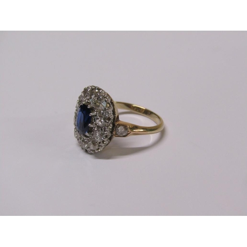 111 - A gold sapphire and diamond ring, central sapphire surrounded by diamond halo with diamond set shank... 