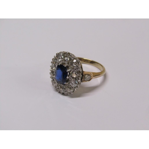 111 - A gold sapphire and diamond ring, central sapphire surrounded by diamond halo with diamond set shank... 