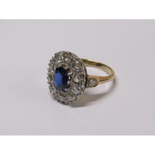 111 - A gold sapphire and diamond ring, central sapphire surrounded by diamond halo with diamond set shank... 