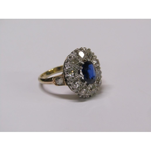 111 - A gold sapphire and diamond ring, central sapphire surrounded by diamond halo with diamond set shank... 