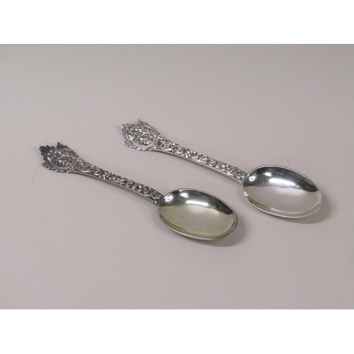 133 - A pair of late Victorian rat tail silver table spoons, the handles profusely chased with mask head t... 