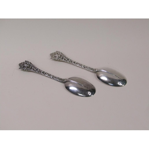 133 - A pair of late Victorian rat tail silver table spoons, the handles profusely chased with mask head t... 