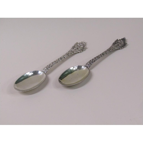 133 - A pair of late Victorian rat tail silver table spoons, the handles profusely chased with mask head t... 