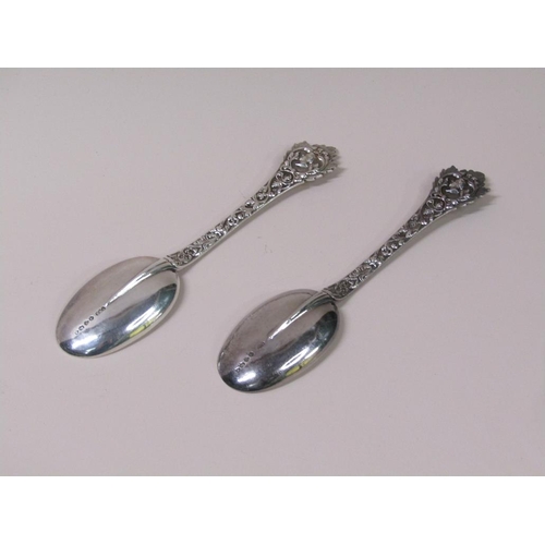 133 - A pair of late Victorian rat tail silver table spoons, the handles profusely chased with mask head t... 