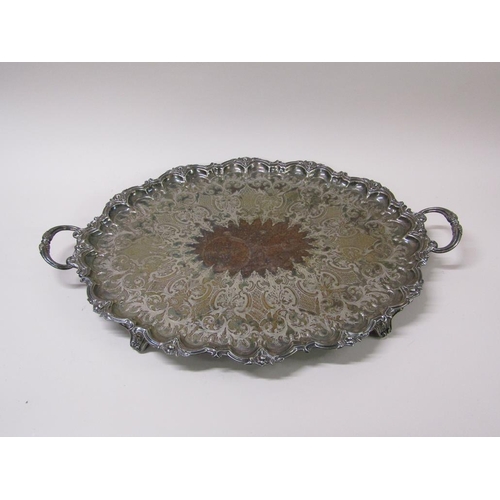 152 - A late Victorian two handled silver plated tea tray with a raised and cast border and engraved with ... 