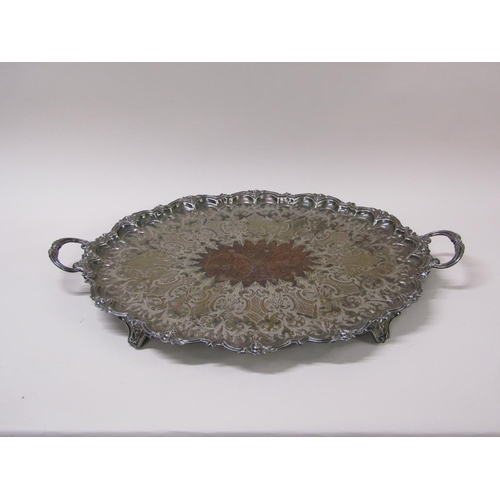 152 - A late Victorian two handled silver plated tea tray with a raised and cast border and engraved with ... 