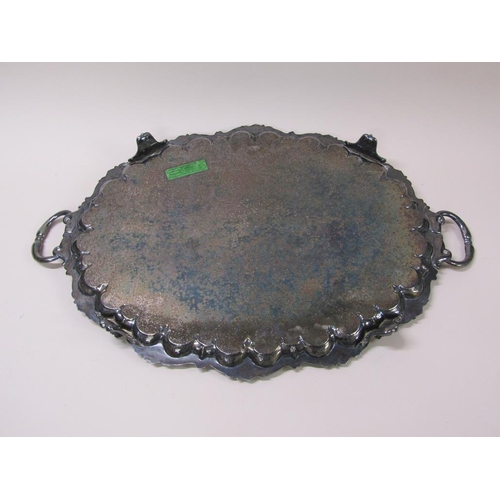 152 - A late Victorian two handled silver plated tea tray with a raised and cast border and engraved with ... 