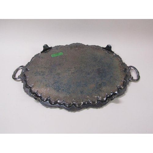 152 - A late Victorian two handled silver plated tea tray with a raised and cast border and engraved with ... 