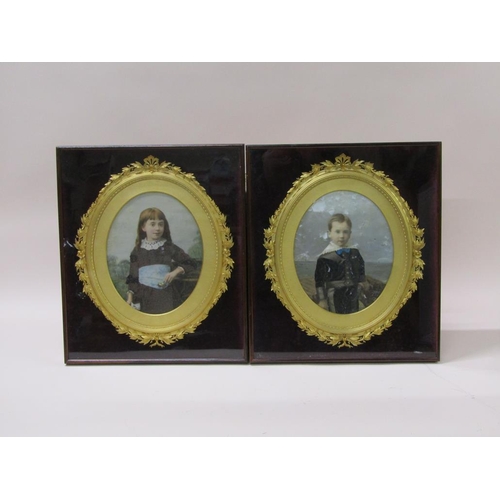 228 - A pair of Edwardian period coloured photographs, boy and girl in oval gilt cased frames, each 30cm x... 