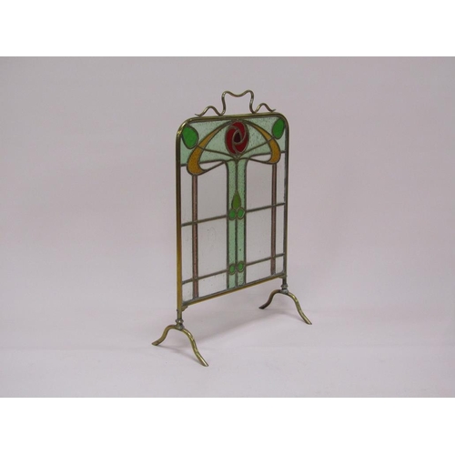 41 - A brass framed Art Nouveau glass fire screen with stylistic coloured glass floral decoration, 48cm w... 