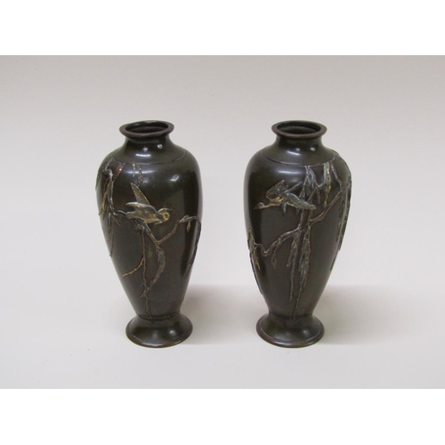 47 - A pair of Japanese Meiji period bronze baluster vases decorated in relief with birds amongst branche... 