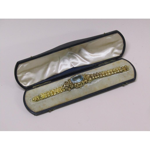 91 - A Continental gold bracelet set with a large central blue stone, in original box, 16cm l (but has tw... 