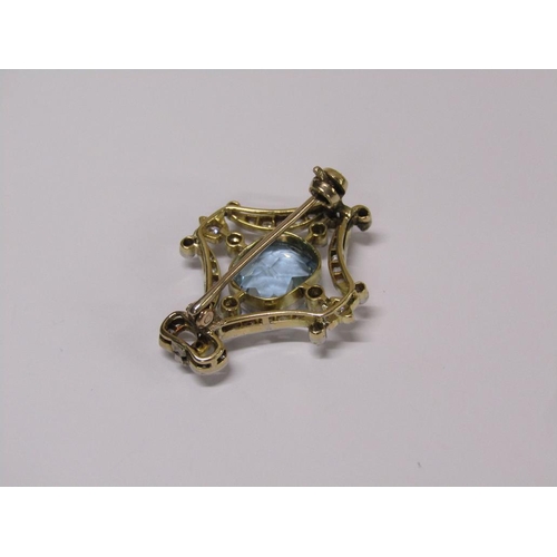 99 - A gold diamond and aquamarine set brooch of bow and swag form, central aquamarine surrounded by grad... 