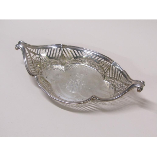 137 - A late Victorian silver basket of boat shaped form with a  raised pierced border and scrolling termi... 