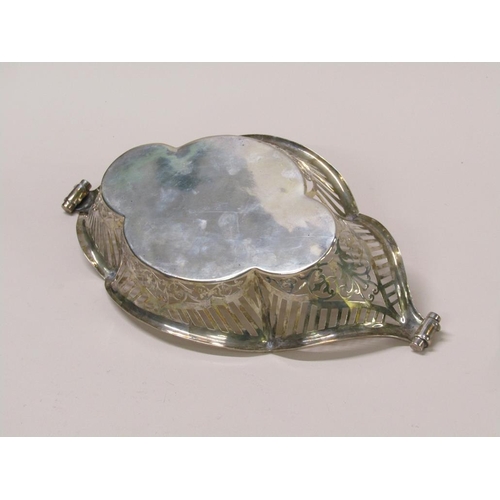 137 - A late Victorian silver basket of boat shaped form with a  raised pierced border and scrolling termi... 