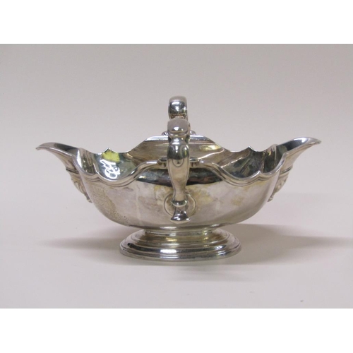 138 - A Georgian style silver sauce tureen, double lipped and having two scrolling handles, London 1972, 2... 