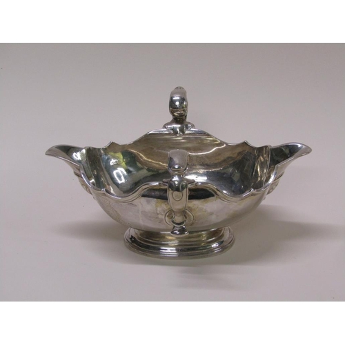 138 - A Georgian style silver sauce tureen, double lipped and having two scrolling handles, London 1972, 2... 