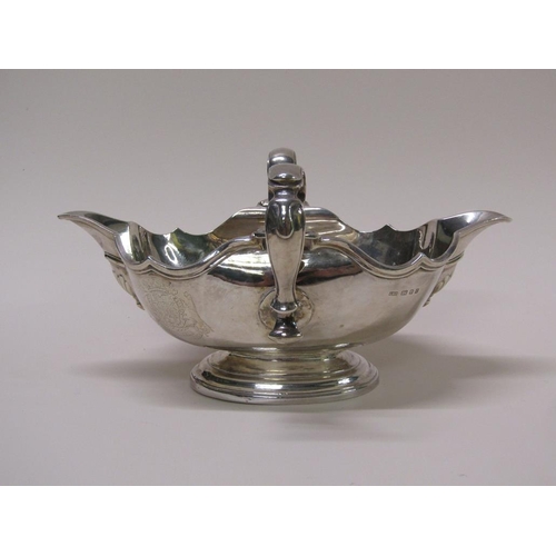 138 - A Georgian style silver sauce tureen, double lipped and having two scrolling handles, London 1972, 2... 