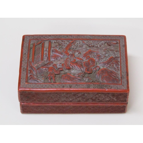 56 - A 19c Chinese cinnabar box, the lift off cover decorated in relief with figures outside a temple, 15... 