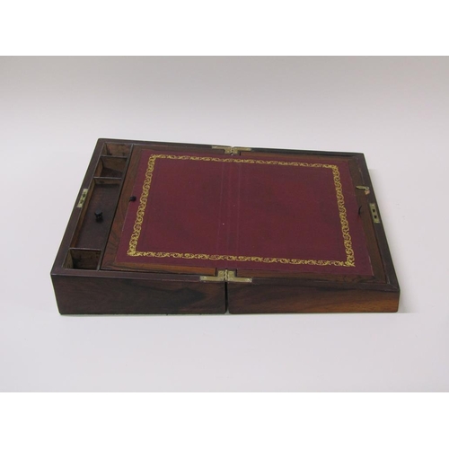 61 - A 19c rosewood writing slope with a fitted interior, leather lined slope over two wells, the hinged ... 