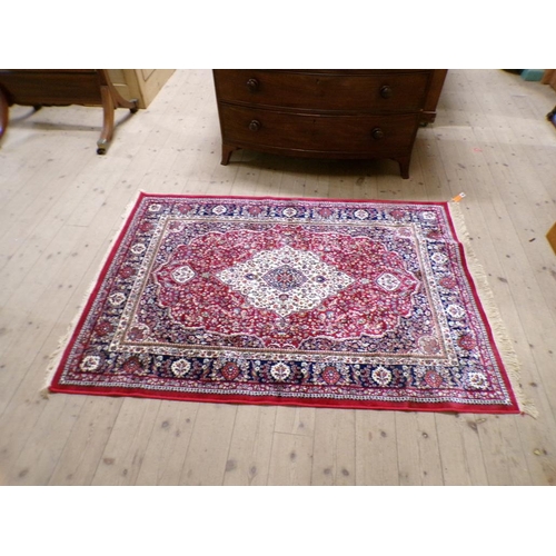 1954 - ORIENTAL WOOLLEN RED GROUND FLORAL PATTERNED RUG 116 x 181 cms