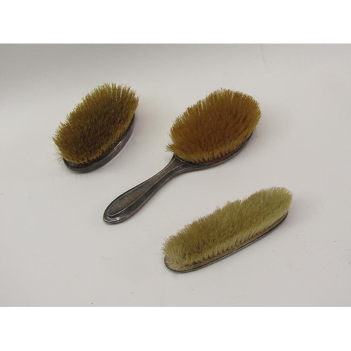 1540 - THREE SILVER HAMMERED BACKED DRESSING TABLE BRUSHES