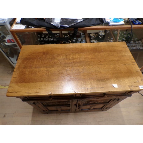 1899 - OAK SIDE CABINET WITH FITTED TWO DRAWERS OVER CUPBOARD ENCLOSED BY TWO CARVED AND PANELLED DOORS 92 ... 