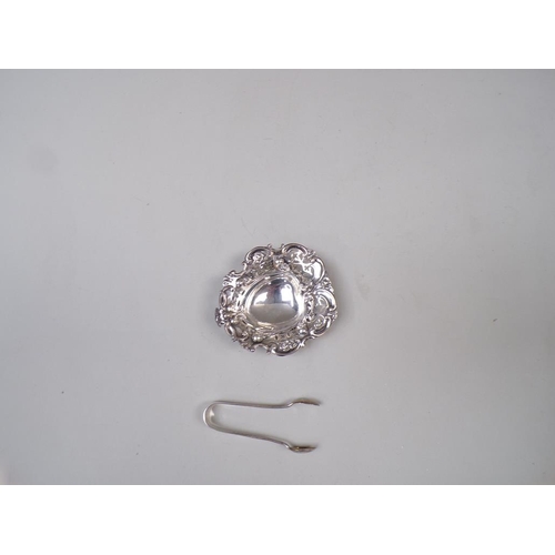 1665 - SMALL SILVER PIERCED DISH AND A PAIR OF SILVER SUGAR TONGS