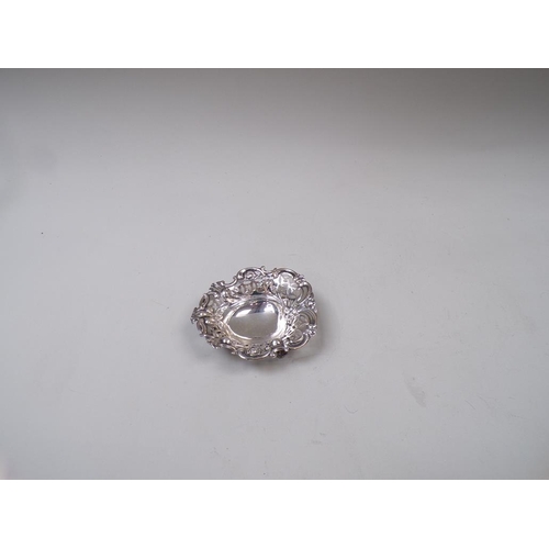 1665 - SMALL SILVER PIERCED DISH AND A PAIR OF SILVER SUGAR TONGS