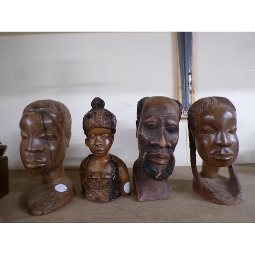 424 - FOUR CARVED HARDWOOD AFRICAN HEADS