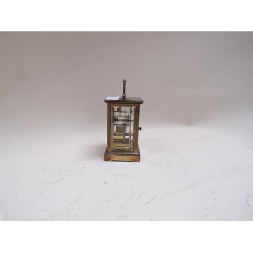 1455 - MATTHEW NORMAN BRASS CARRIAGE CLOCK 14cms H WITH THE HANDLE RAISED